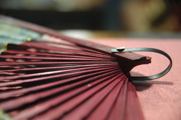 woman hand fan wooden red color close up - Photo, Image