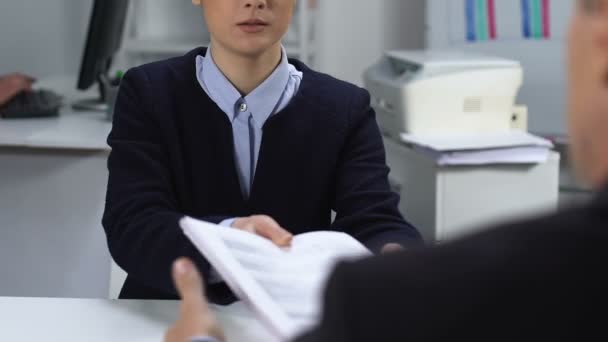 Female office worker giving stack of documents to male manager, office paperwork - Filmmaterial, Video