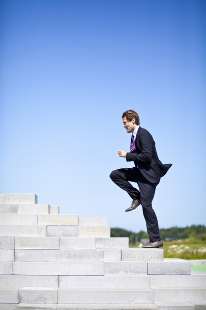 Businessman running up stairs - Photo, Image
