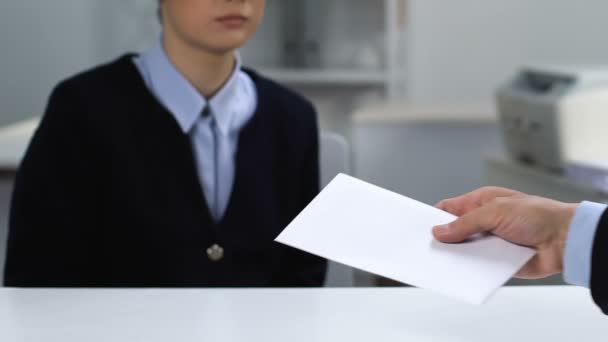 Office worker taking envelope from male employer, illegal salary payment, bonus - Felvétel, videó