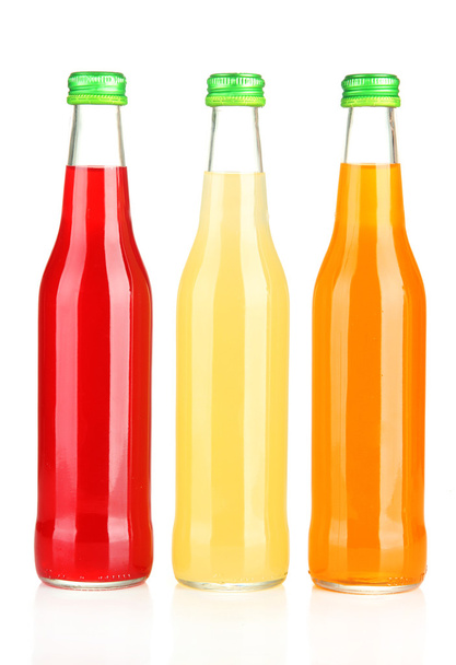 Bottles with tasty drink, isolated on white - 写真・画像