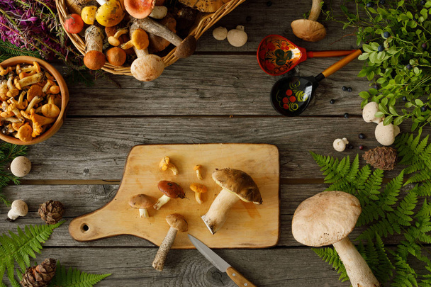 Mushrooms on old wooden background. Card on autumn or summertime - 写真・画像