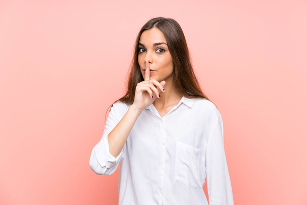 Young woman over isolated pink background doing silence gesture - Foto, Imagem