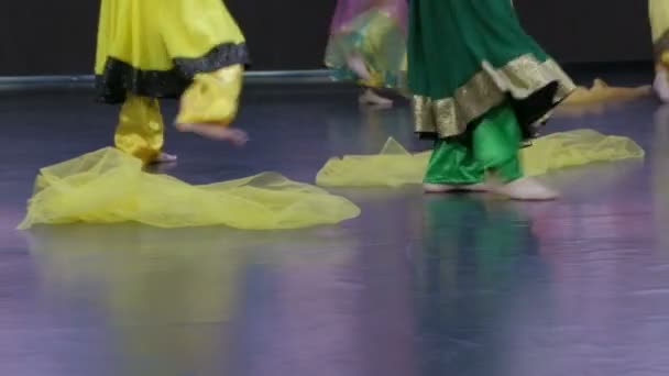 インド舞踊ステージ上の若いダンサーの足のクローズアップ。黄色と緑の服. - 映像、動画