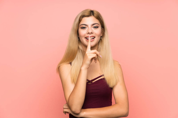 Teenager girl over isolated pink background doing silence gesture - Foto, immagini