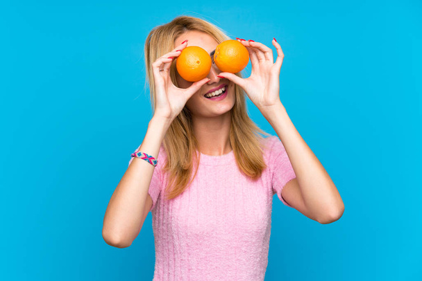 Happy  Young blonde woman holding fruits - Φωτογραφία, εικόνα