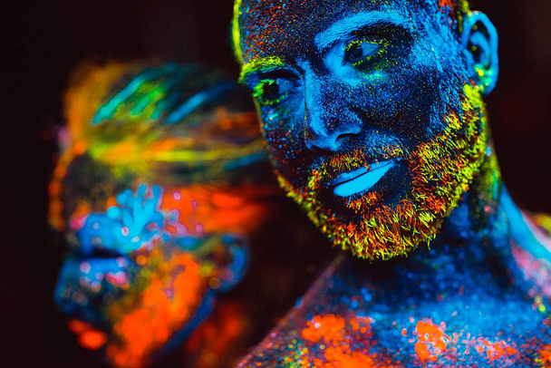 Portrait of a pair of lovers painted in fluorescent powder. - Fotografie, Obrázek