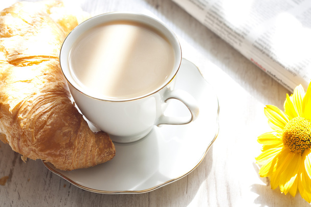 Croissant and cup of coffee in the morning closeup - Фото, изображение