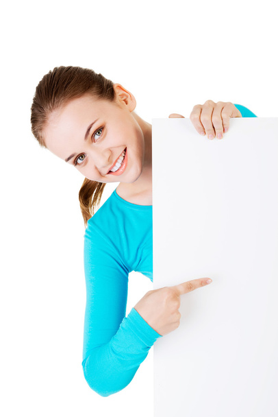 Portrait young happy woman with blank board - 写真・画像