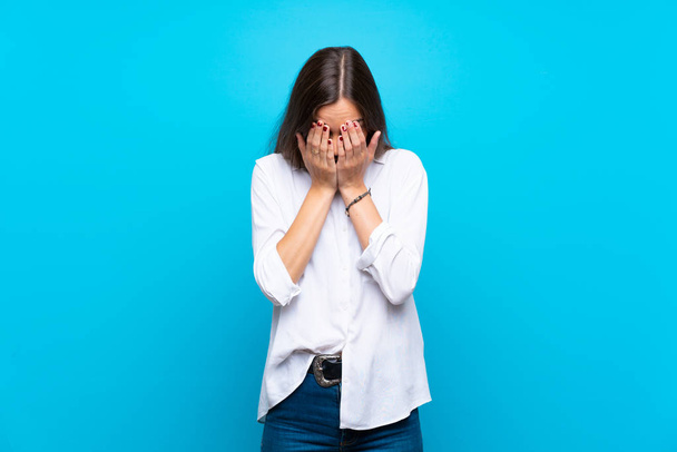 Young woman over isolated blue background with tired and sick expression - Photo, Image