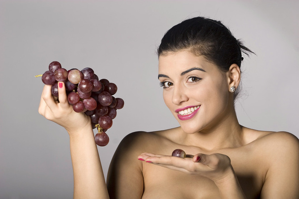Woman holding red grapes - Photo, Image