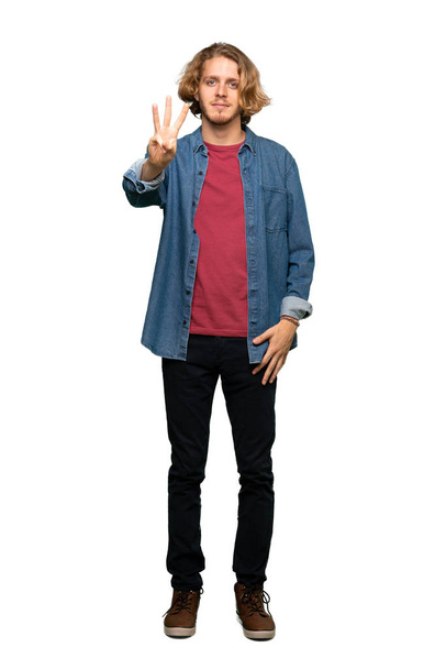 Full-length shot of Blonde man happy and counting three with fingers over isolated white background - Photo, Image
