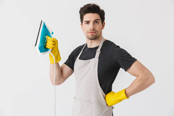 Handsome brunette houseman wearing apron - Photo, Image