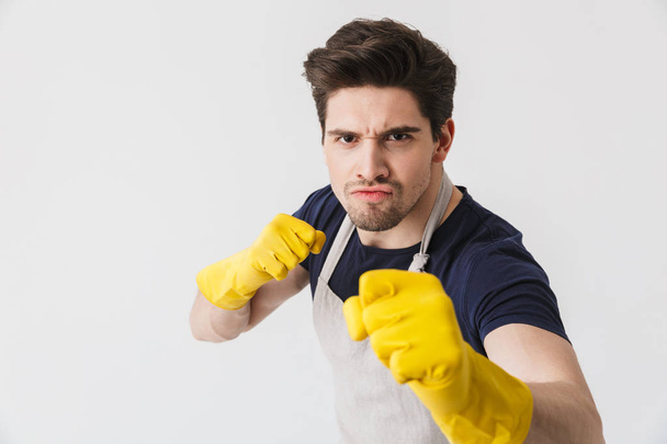 Photo of muscular young man wearing yellow rubber gloves for han - Zdjęcie, obraz