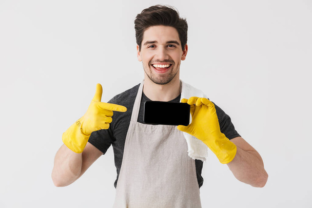 Handsome brunette houseman wearing apron - Valokuva, kuva