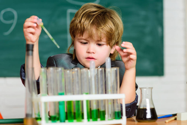 Chemical analysis. Science concept. Wunderkind experimenting with chemistry. Boy use microscope test tubes chemistry school classroom. Kid study chemistry. Biotechnology and pharmacy. Genius pupil - Fotoğraf, Görsel