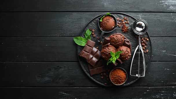Ice cream with chocolate. Making ice cream on Wooden background. Top view. Free space for your text. - Photo, image