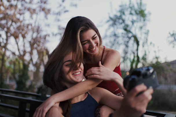 Kaksi nuorta naista ottaa selfien parvekkeella
. - Valokuva, kuva