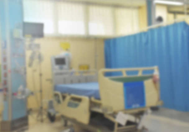 Blurred the bed in intensive care unit at hospital. There are many machines and equipment for care patient. Blurred background. - Photo, Image