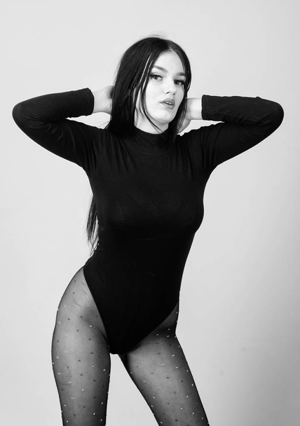 woman with sexy fit body. beauty with long brunette hair. seduction. Fitness and diet. underwear fashion. sexy girl in bodysuit and tights. Beautiful legs. Flaunting her femininity - Φωτογραφία, εικόνα