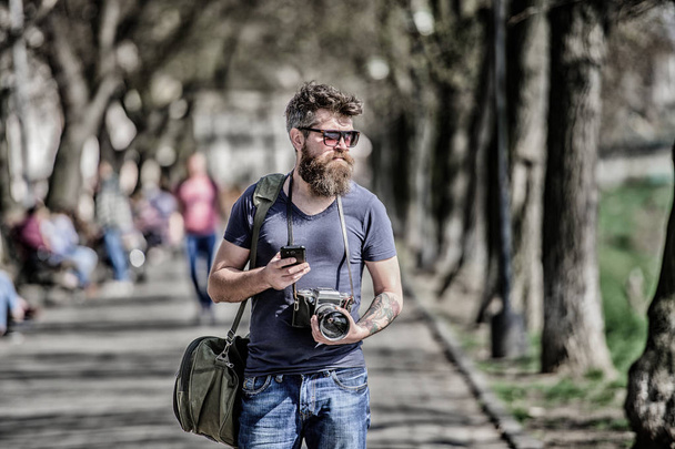 Photographer hold vintage camera. Modern blogger. Manual settings. Photographer with beard and mustache. Tourist shooting photos. Content creator. Man bearded hipster photographer. Old but still good - 写真・画像