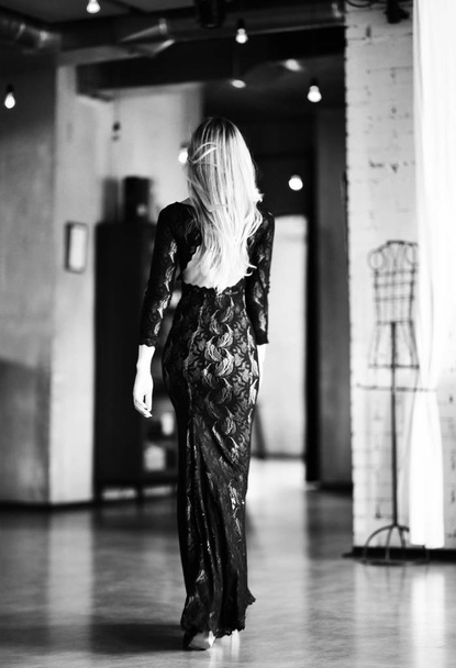 Young beautiful woman walking in long fashion dress in expensive restaurant place - Фото, зображення