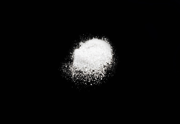white sugar hill on a black mirror background - Photo, Image