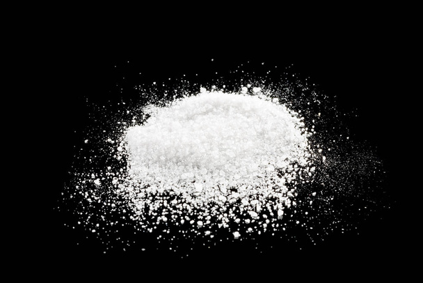 white sugar hill on a black mirror background - Fotó, kép