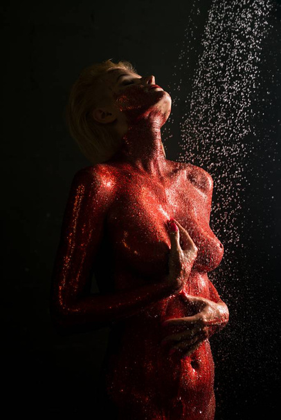 Naked girl covered with red color in shower - Fotografie, Obrázek