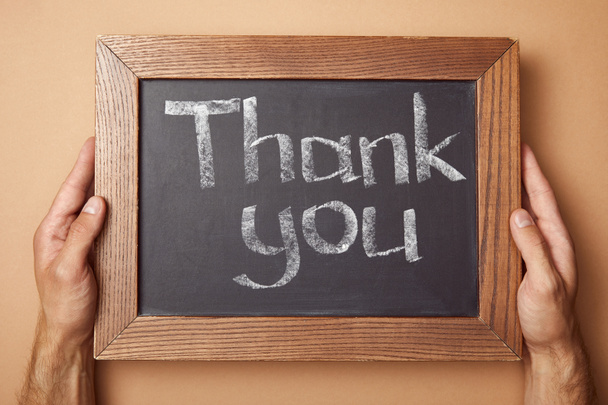 cropped view of man holding chalkboard with thank you lettering - Photo, Image