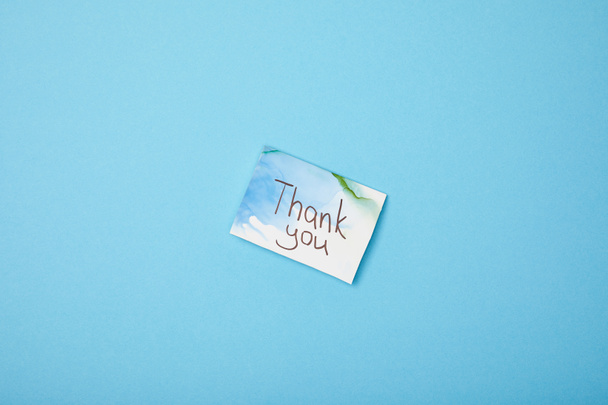 greeting card with thank you lettering on blue background with copy space - Photo, Image
