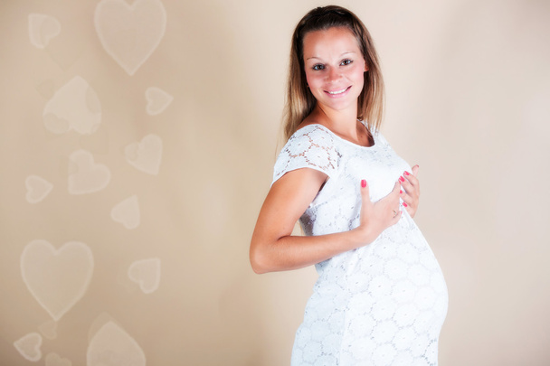 Pregnant woman in studio - Фото, изображение