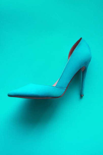 Photo of trendy fancy modern fashionable women luxury cyan high heel shoe on a cyan background in studio - Φωτογραφία, εικόνα