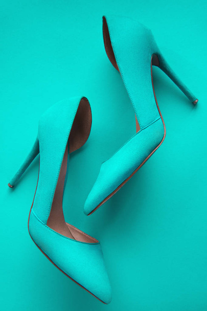 Photo of trendy fancy modern fashionable women luxury cyan pair of high heel shoes on a cyan background in studio - Fotoğraf, Görsel
