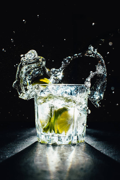 ice cold cocktail with lime on a black background - Fotoğraf, Görsel