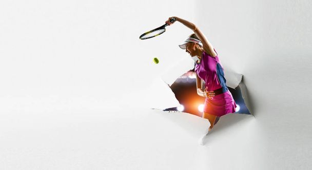 Paper breakthrough hole effect and tennis player - Foto, afbeelding