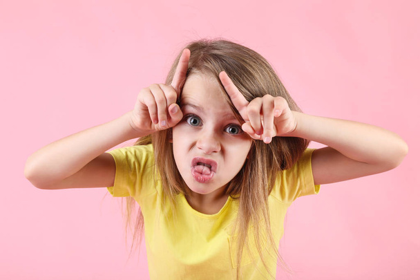 Emotional little girl on pink background - Foto, immagini