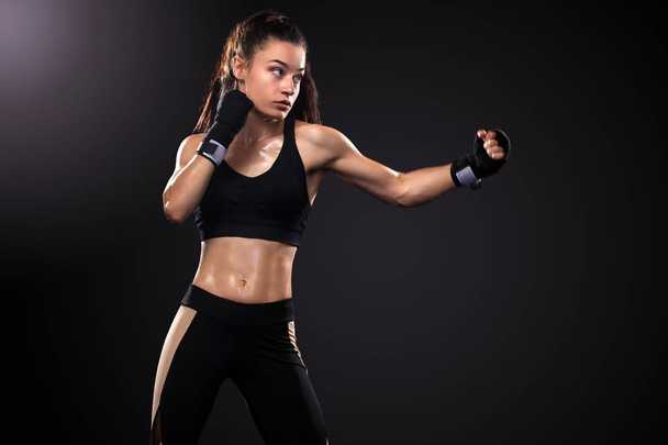 Woman boxer on black background. Boxing and fitness concept. - Foto, Imagem