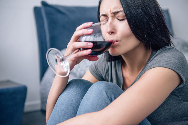 beautiful depressed woman drinking wine at home - Photo, Image