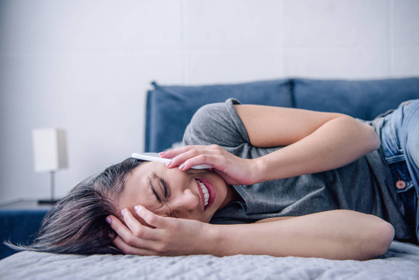 самотня депресивна жінка на ліжку говорить на смартфоні в спальні
 - Фото, зображення