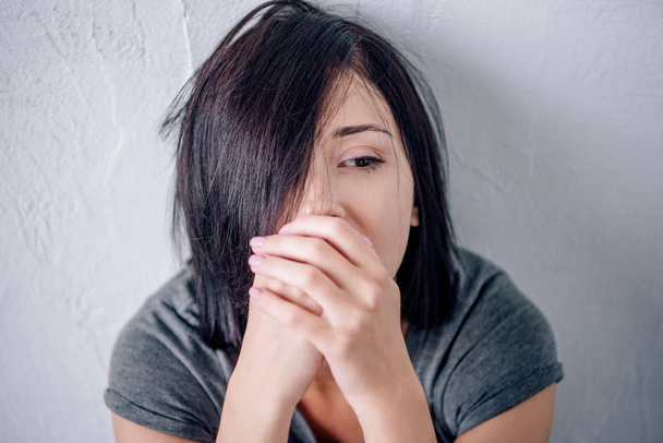 beautiful depressed brunette woman covering mouth at home - Photo, Image
