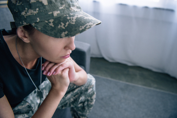 sad woman in military uniform at home with copy space - Fotoğraf, Görsel