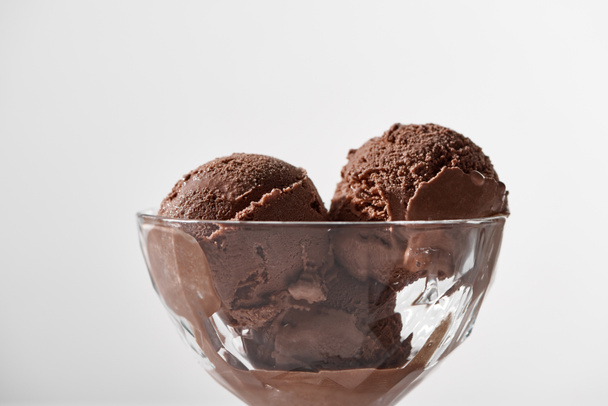 close up view of fresh delicious chocolate ice cream in glass bowl isolated on grey - Fotografie, Obrázek