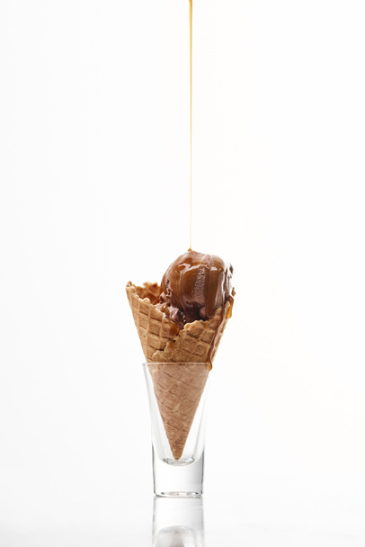 delicious sweet ice cream in crispy waffle cone with dripping chocolate isolated on white - Foto, afbeelding