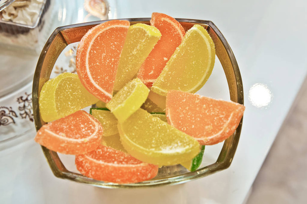 Kép gyümölcs lekvár cukorka. Narancs és sárga lekvár van elhelyezett-ra egy fehér háttér, vízszintes fénykép. Makró fotó élelmiszer desszert zselés édesség. Textúra háttér gyümölcs Jelly édességek cukorka. - Fotó, kép