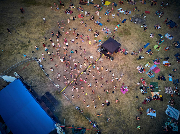 BIALOBRZEGI, POLAND - JULY 13-15, 2019: Beautiful panoramic aerial drone view on people having fun during concert on the Wibracje 3.0 Festival Poland - one of the biggest open air festivals in Poland - Photo, Image