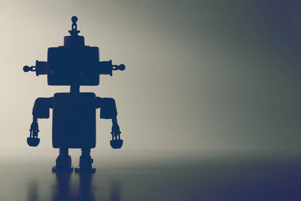 Silhouette of a cute robot on a gray background. - Фото, зображення