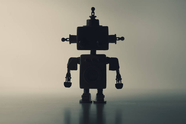Silhouette of a cute robot on a gray background. - Zdjęcie, obraz