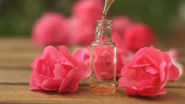 Essence of rose on table in beautiful glass bottle - Footage, Video