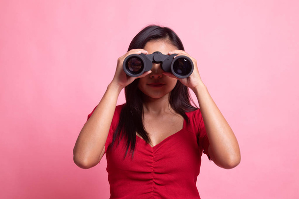 Young Asian woman with binoculars. - Фото, зображення